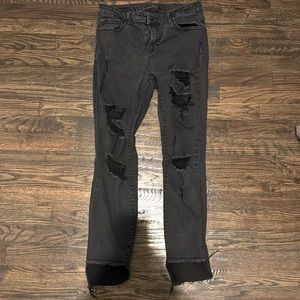 pair of black jeans with rips